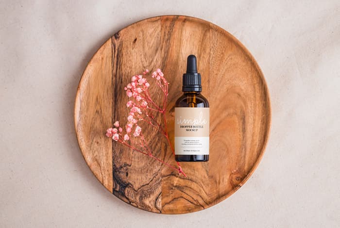 Amber bottle with dried flowers mockup