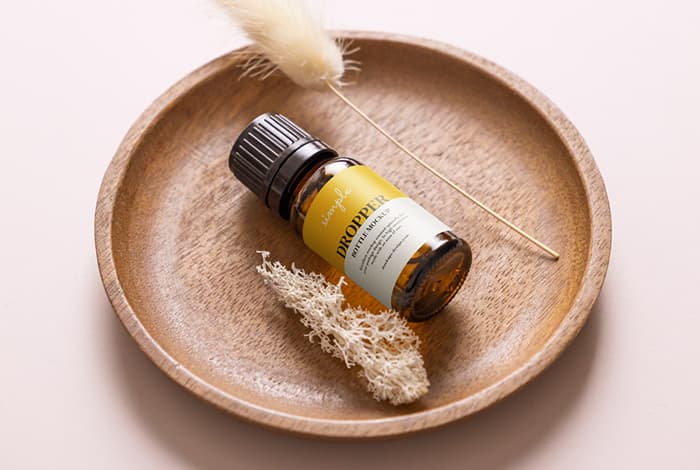 Essential oil bottle in the bowl mockup