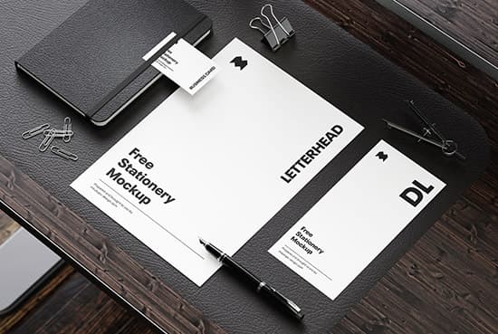 Stationery on the wooden desk mockup