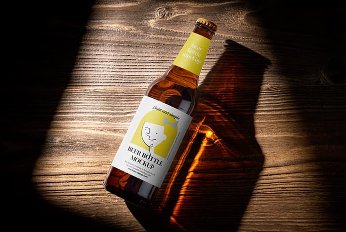 Beer bottle on wooden background mockup