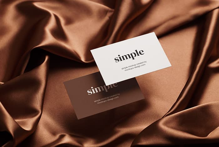 Two business cards on satin background mockup