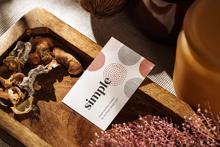 Business card on wooden tray PSD