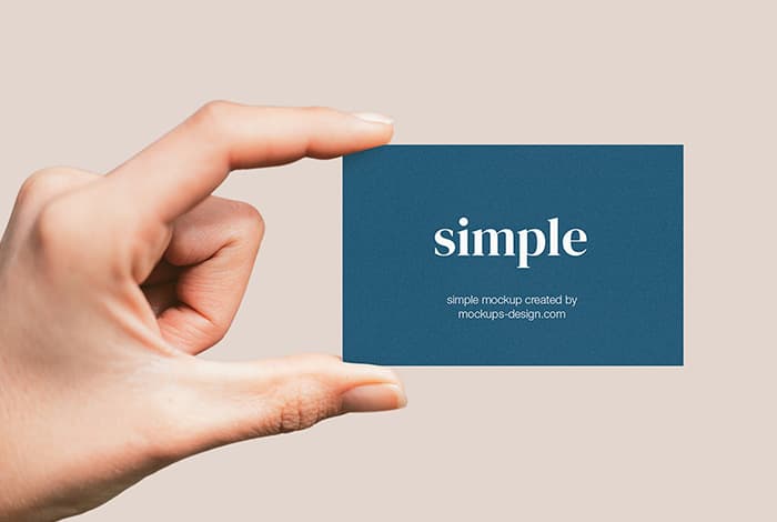 Hand holding business card mockup